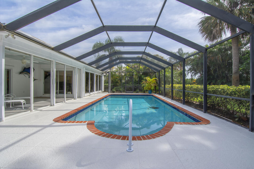 3372 Southeast Court Drive Stuart, FL 34997 - Photo 4 of 33 a view of a swimming pool with a porch
