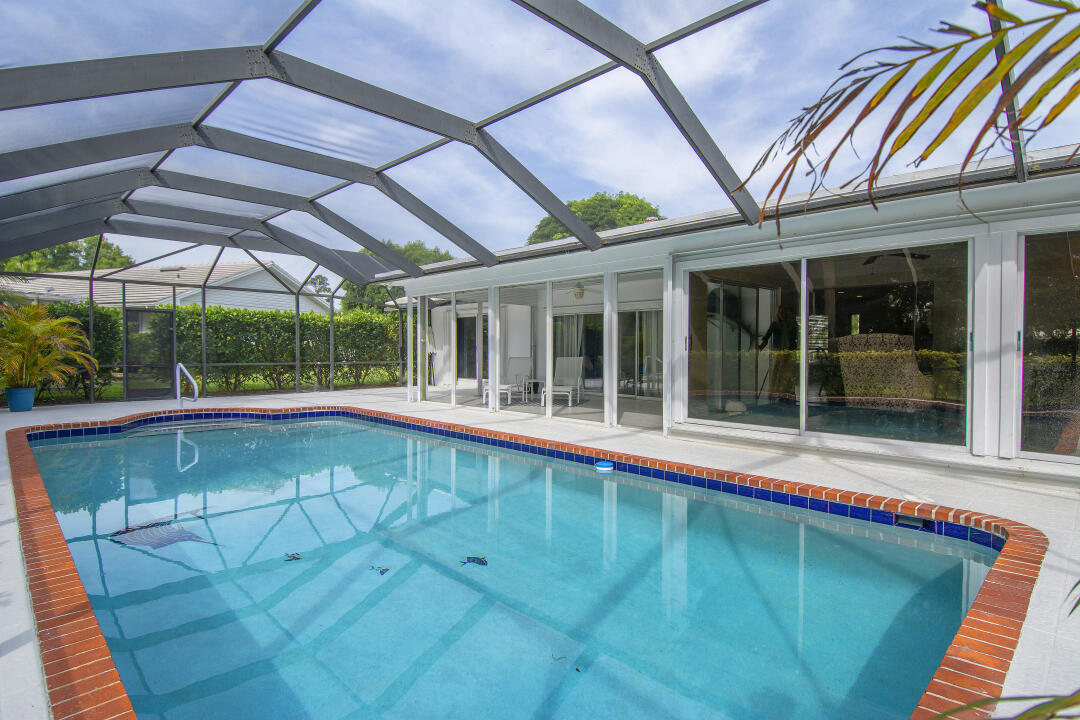 3372 Southeast Court Drive Stuart, FL 34997 - Photo 5 of 33 a view of a patio with a table and chairs under an umbrella