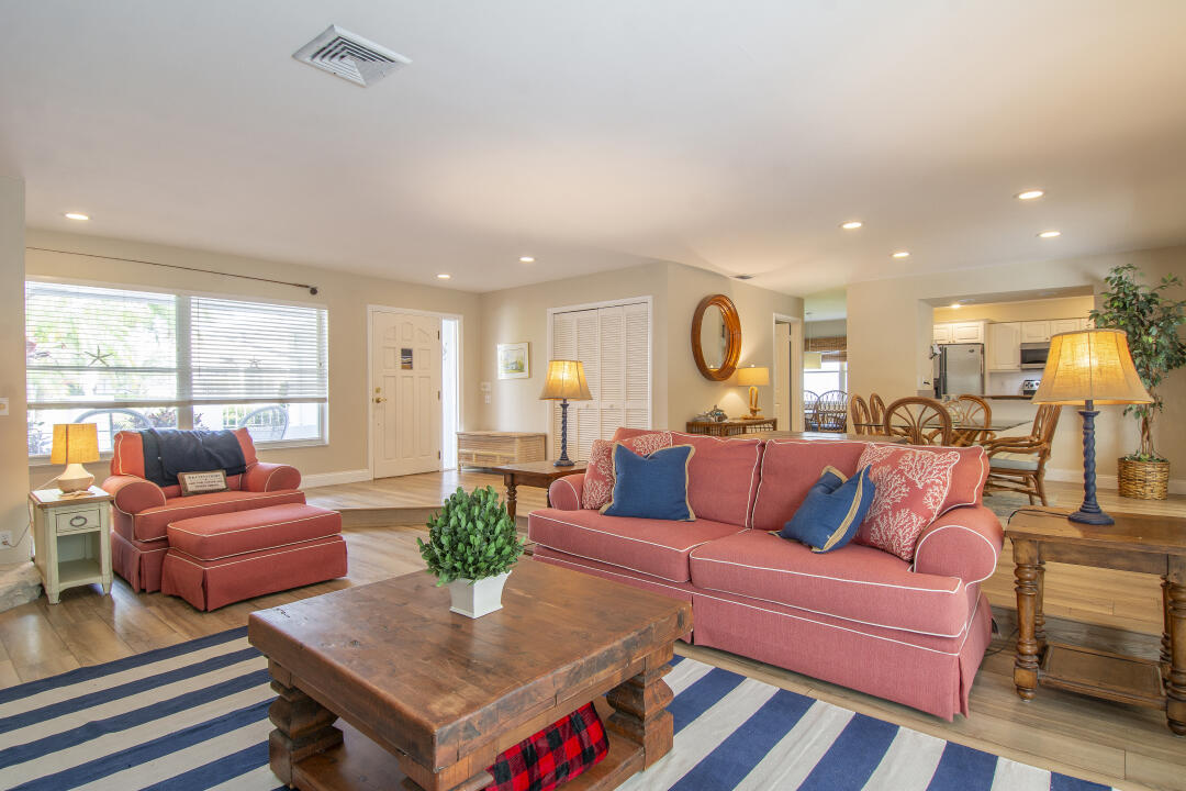 3372 Southeast Court Drive Stuart, FL 34997 - Photo 9 of 33 a living room with furniture kitchen view and a large window