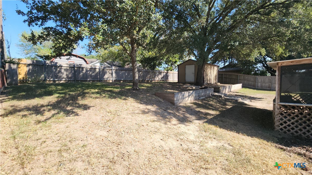 204 Cherokee Lane Victoria, TX 77901 - Photo 14 of 14 a front view of a house with a yard covered with snow and trees