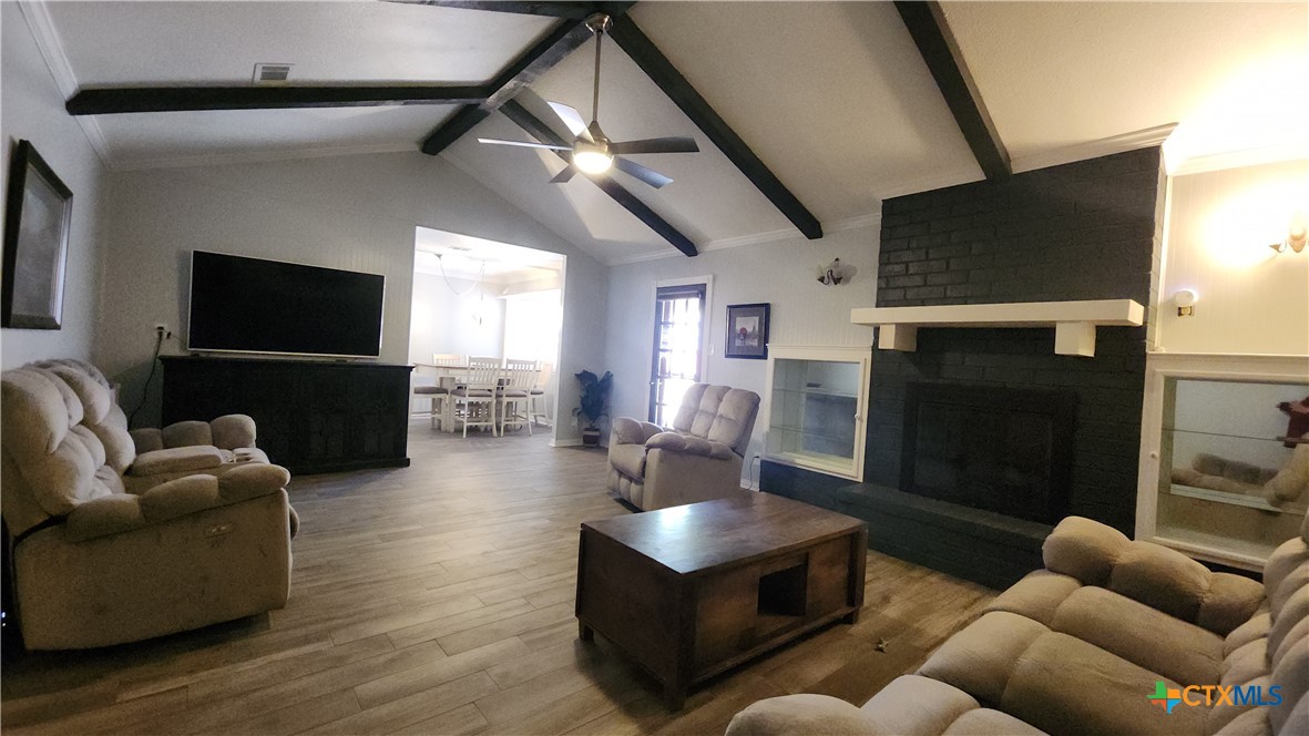 204 Cherokee Lane Victoria, TX 77901 - Photo 3 of 14 a living room with furniture a flat screen tv and a fireplace