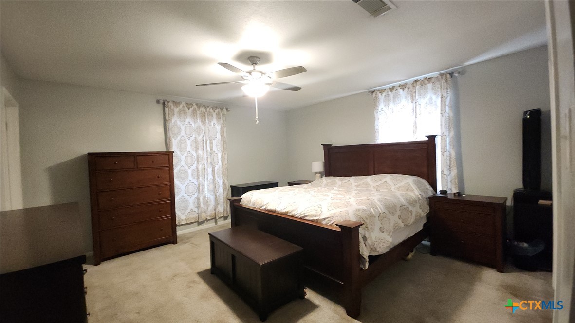 204 Cherokee Lane Victoria, TX 77901 - Photo 8 of 14 a bedroom with a bed and wooden floor