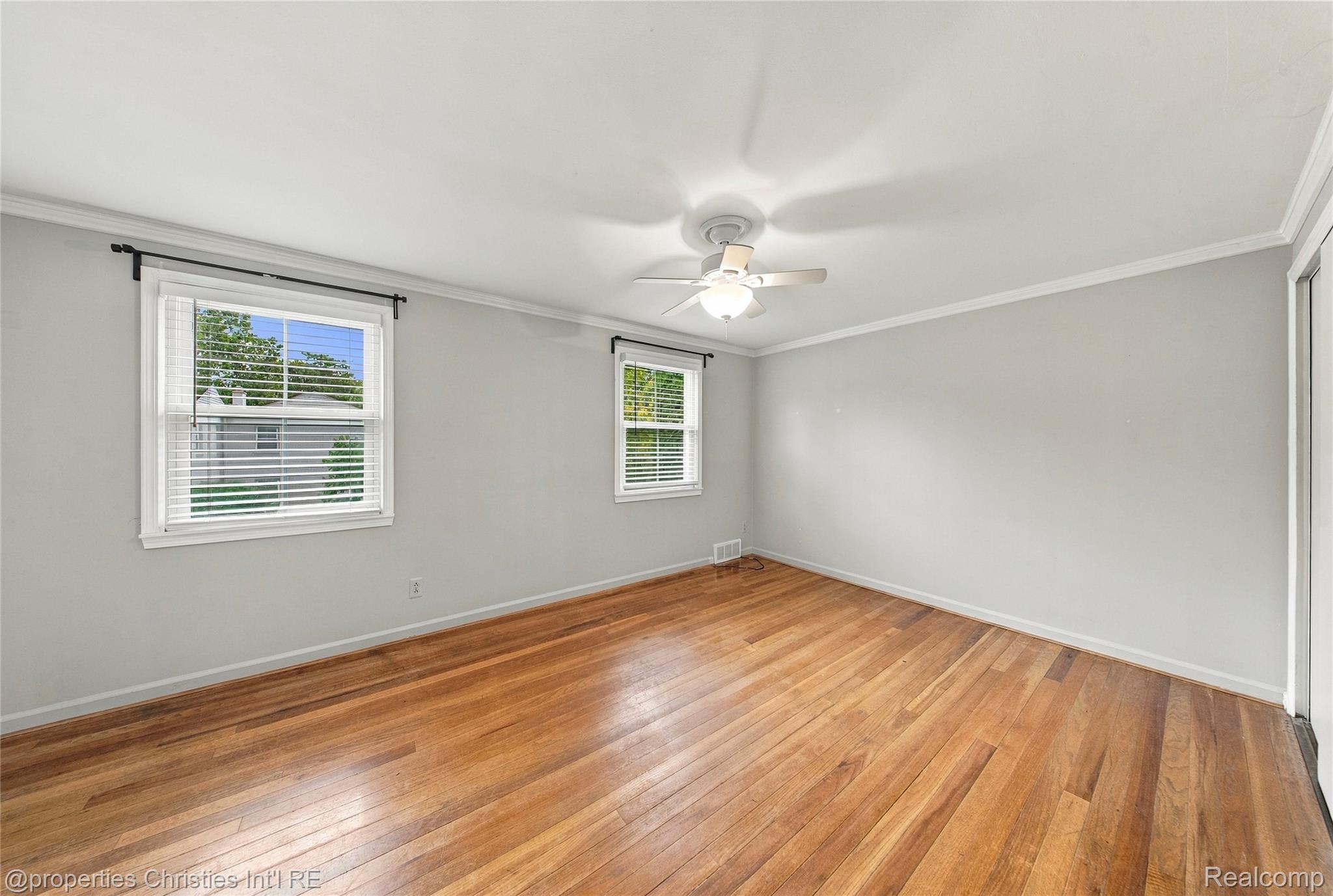 1642 Graefield Road, Unit 75 Birmingham, MI 48009 - Photo 12 of 25 Wood-finish flooring with white trim and crown molding