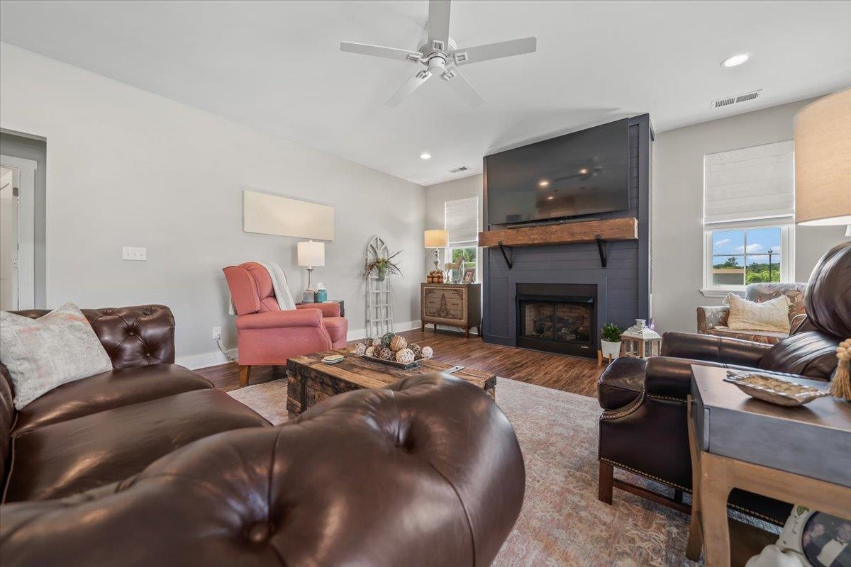 415 Abbey Road, Unit D Munford, TN 38058 - Photo 6 of 35 Living area featuring a fireplace with a dark paneled surround and a substantial wood mantle