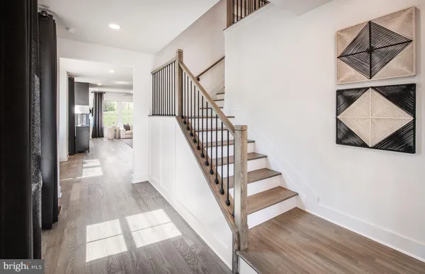 a view of entryway and hall with wooden floor