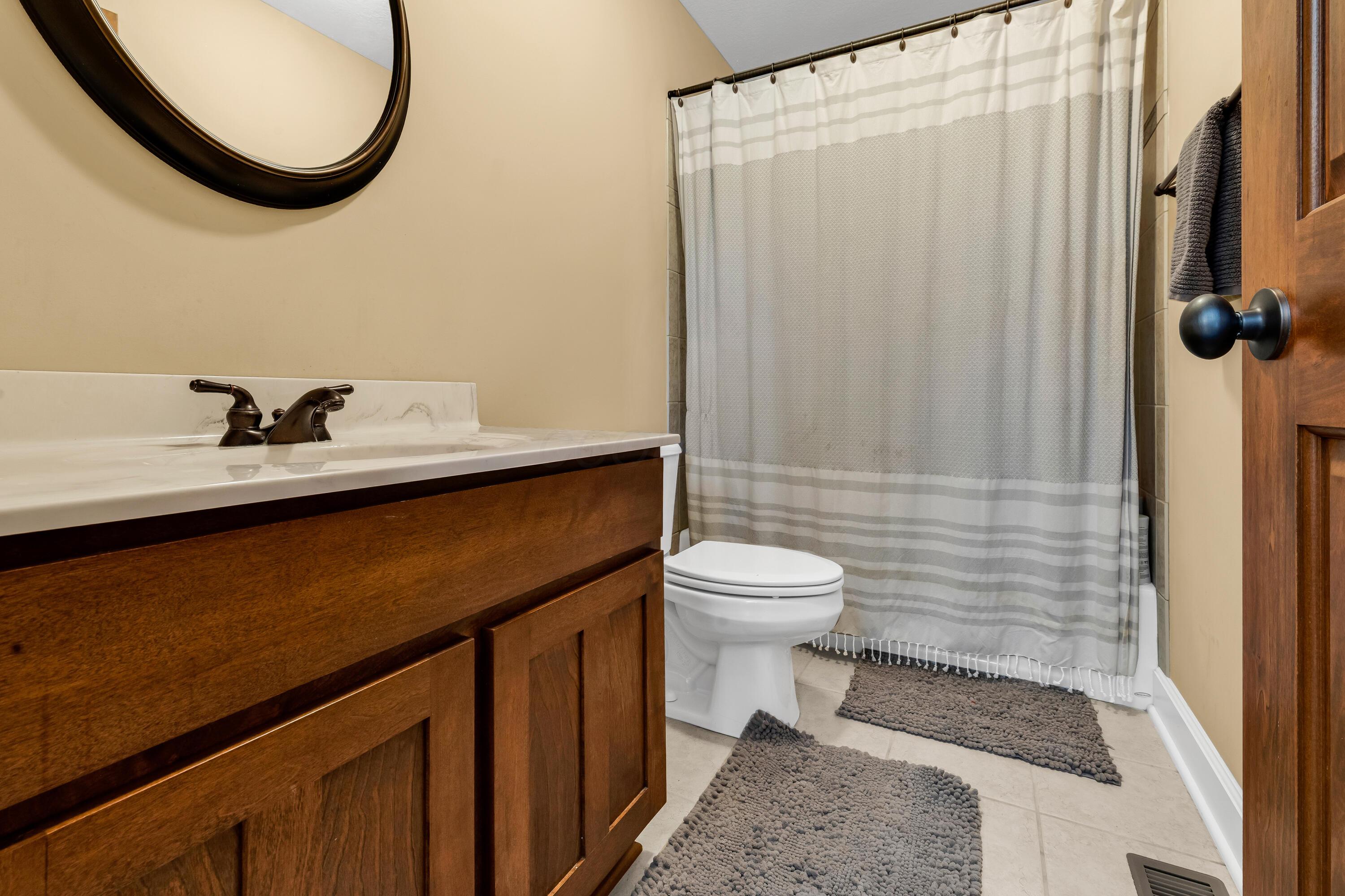 16689 Bailor Road Laurelville, OH 43135 - Photo 39 of 73 • Ceramic tile flooring
• Tan painted walls
• Enclosed vanity with
single bowl, cultured
marble sinktop
• 3 bulb wall light
• Ceiling light
• Ceiling exhaust
• Tub/shower combination
with ceramic tile surround