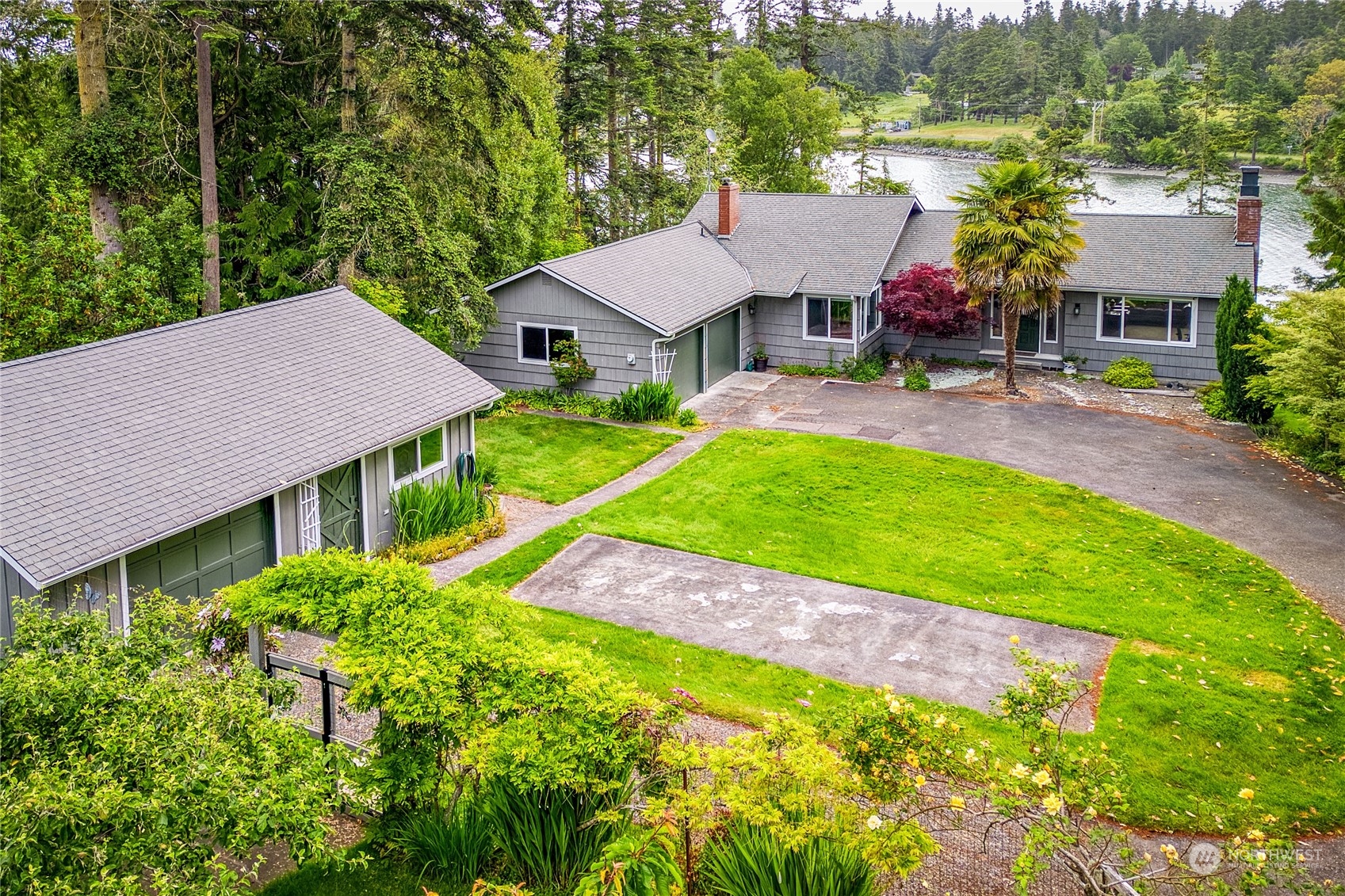 an aerial view of a house with swimming pool garden and patio