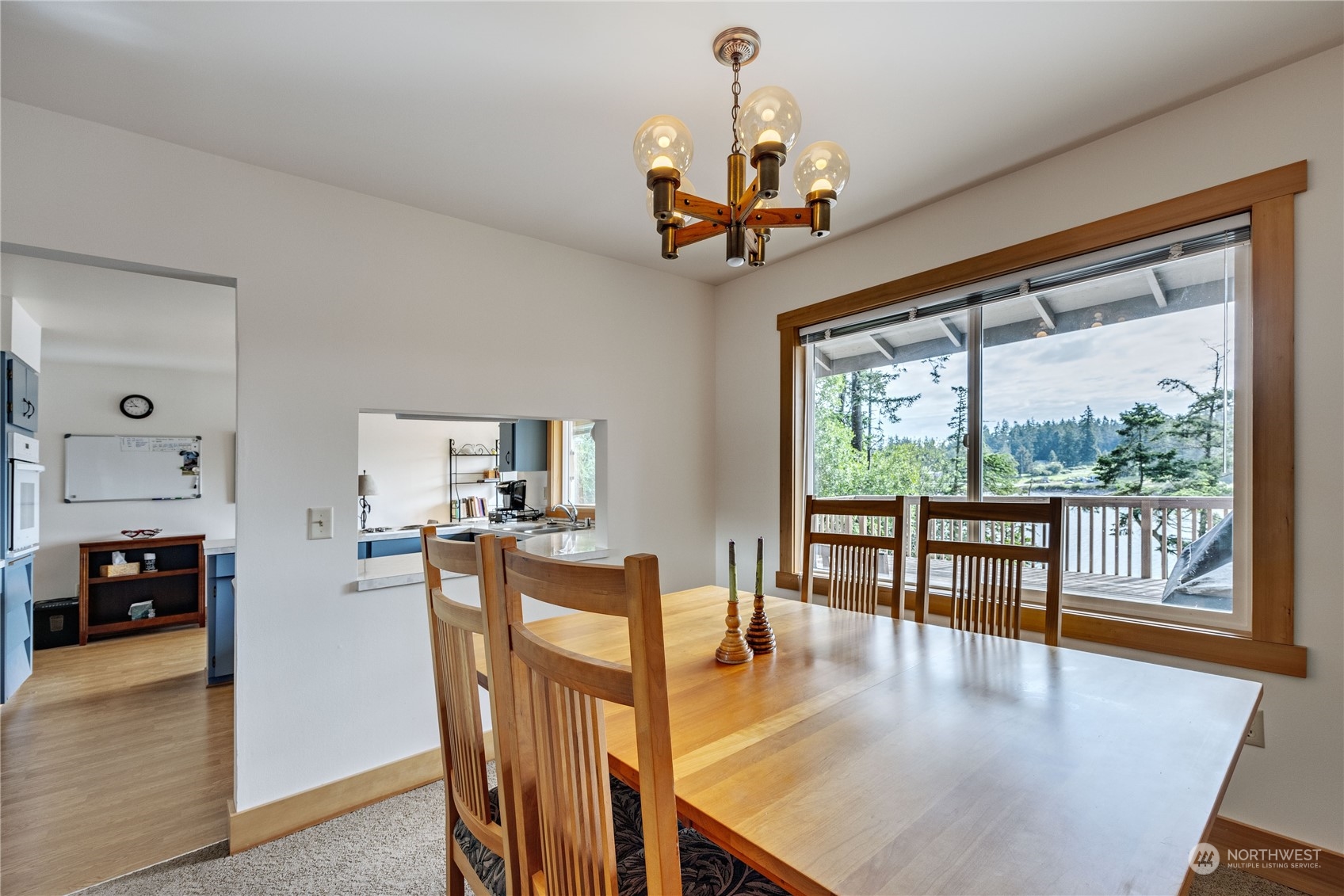 1511 Griffith Point Road Nordland, WA 98358 - Photo 11 of 40 a view of a dining room and livingroom with furniture wooden floor a chandelier