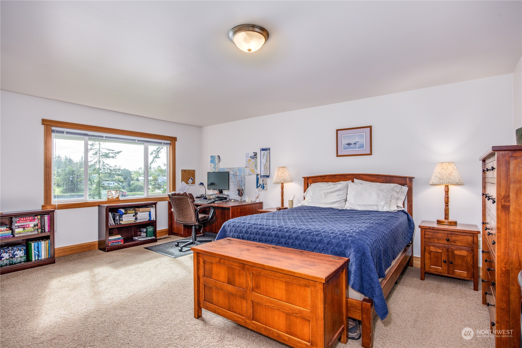 1511 Griffith Point Road Nordland, WA 98358 - Photo 17 of 40 a bedroom with a bed and a chandelier next to a window