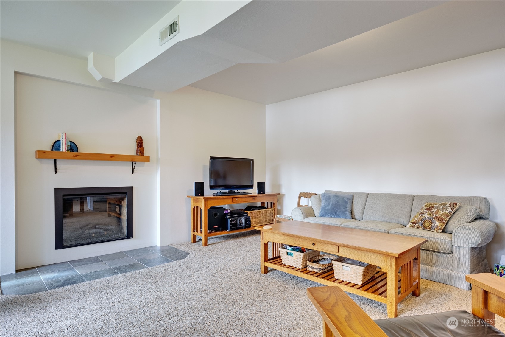 1511 Griffith Point Road Nordland, WA 98358 - Photo 27 of 40 a living room with furniture and a fireplace