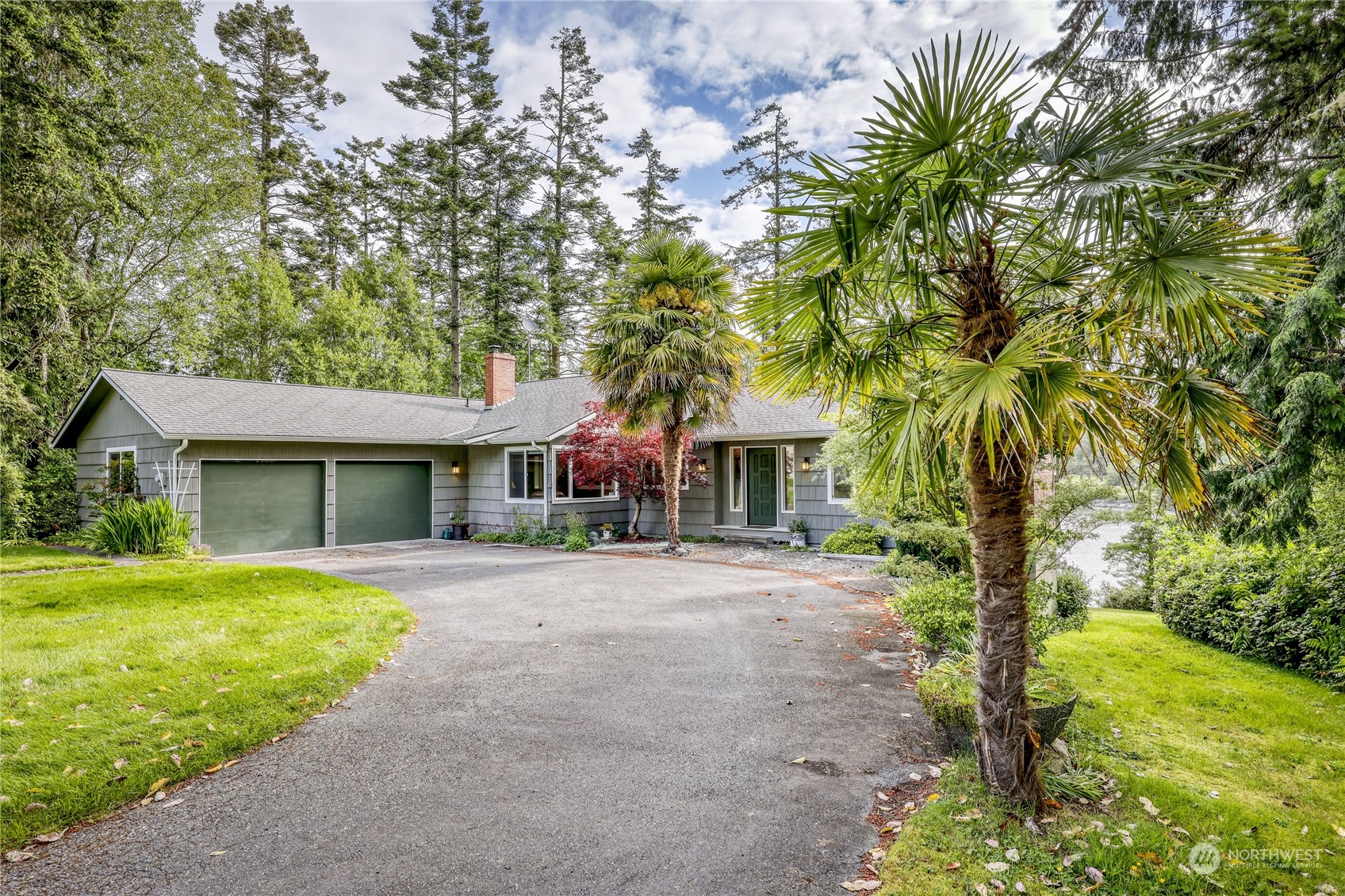 1511 Griffith Point Road Nordland, WA 98358 - Photo 35 of 40 a front view of a house with a yard and trees