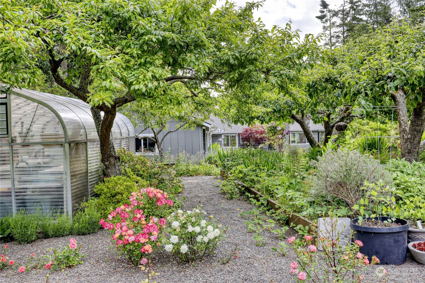 1511 Griffith Point Road Nordland, WA 98358 - Photo 5 of 40 a front view of a house with a yard and fountain