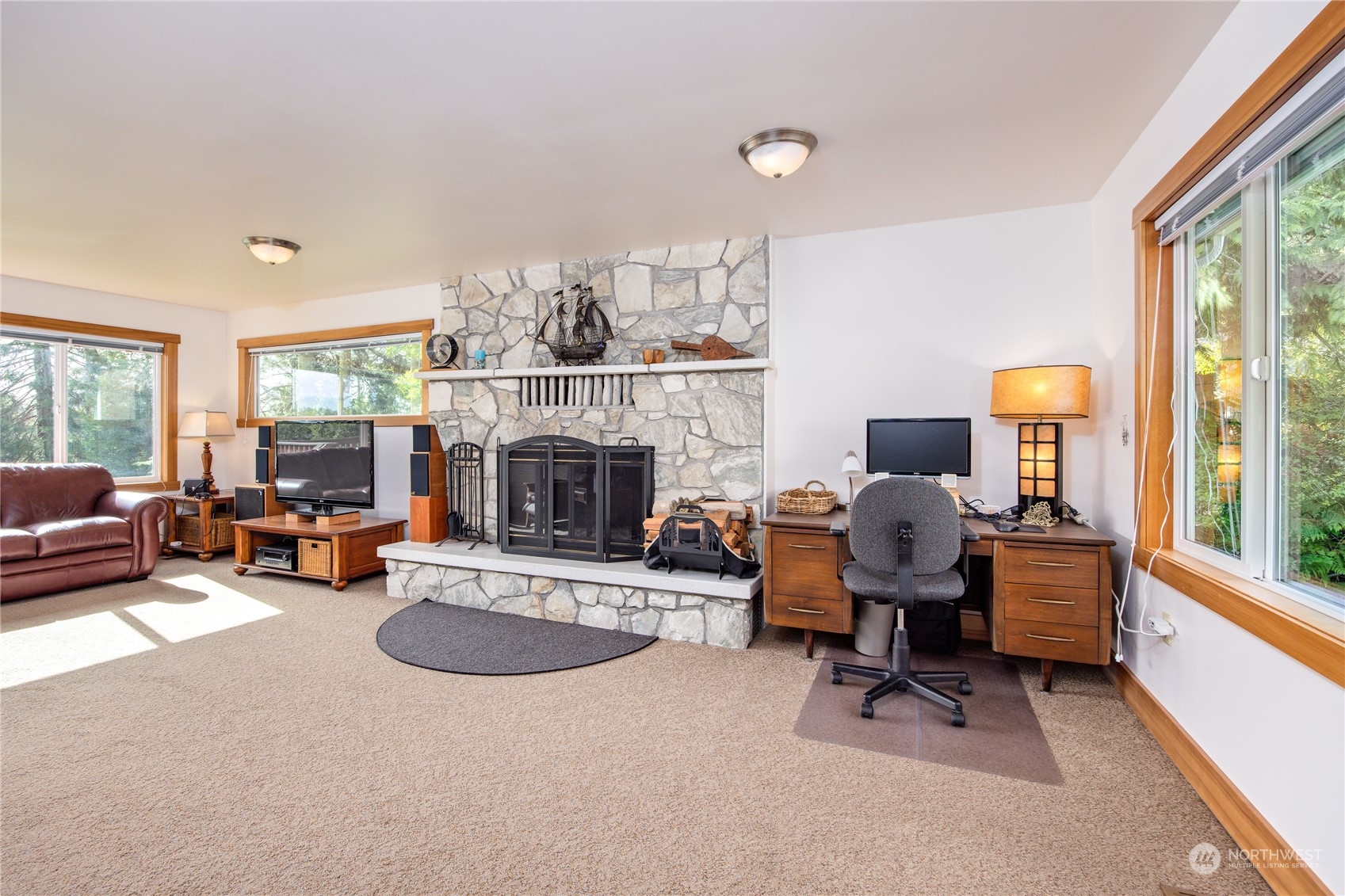 1511 Griffith Point Road Nordland, WA 98358 - Photo 8 of 40 a living room with furniture and a fireplace