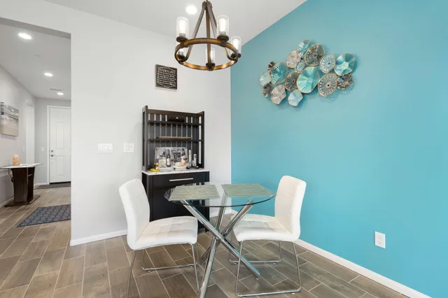 a view of a dining room with furniture and chandelier