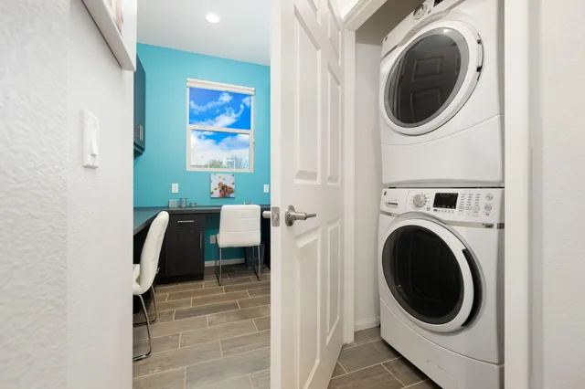 a view of a bedroom with washer and dryer