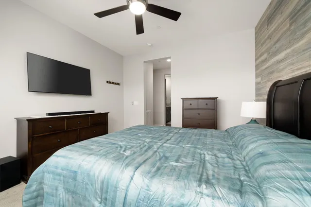 a bedroom with a bed and a flat screen tv