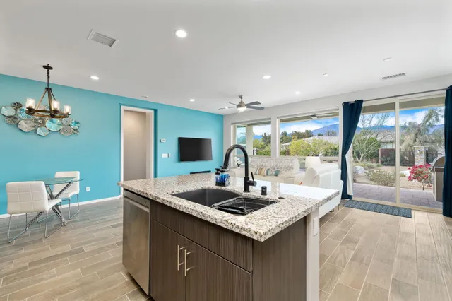 a kitchen with a sink and living room