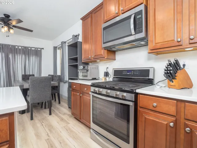 a large kitchen with stainless steel appliances granite countertop a lot of counter space and a sink