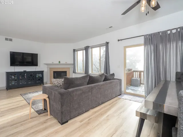 a living room with furniture fireplace and a flat screen tv