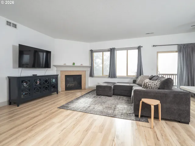 a living room with furniture and kitchen view