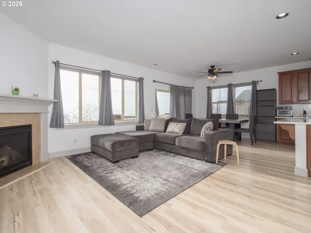 a large bed sitting in a bedroom next to a window with a chandelier