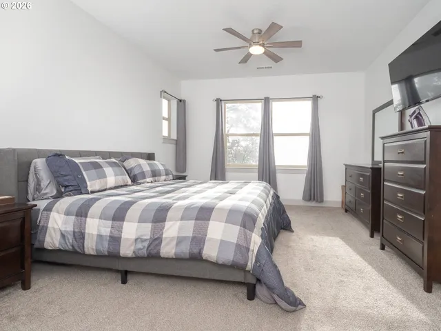 a bedroom with a bed and a television