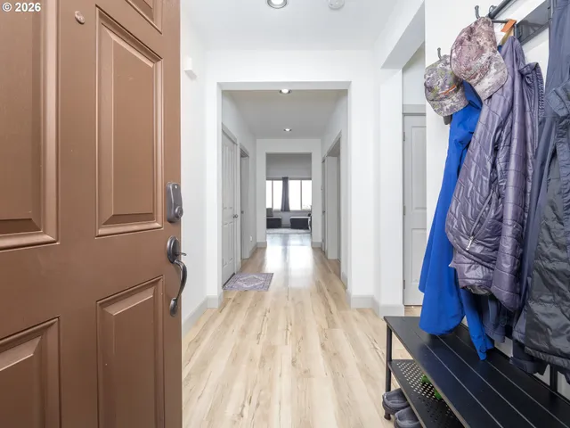 a view of an entryway with wooden floor