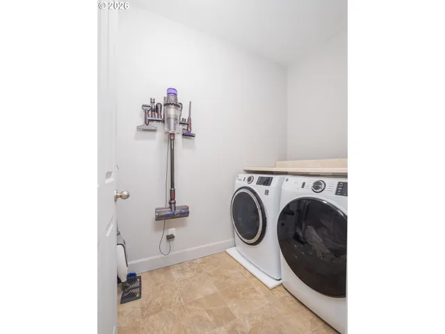 a kitchen with stainless steel appliances granite countertop a stove a refrigerator a sink and a oven with wooden floor