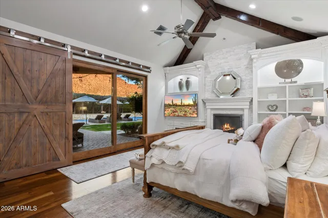 a bedroom with a bed and a fireplace