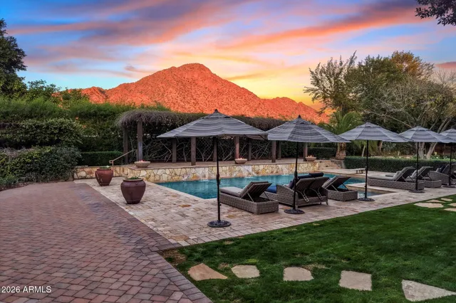a view of a house with garden and sitting area