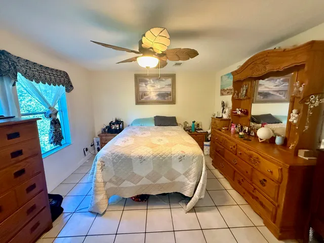 a bed room with a bed and a mirror