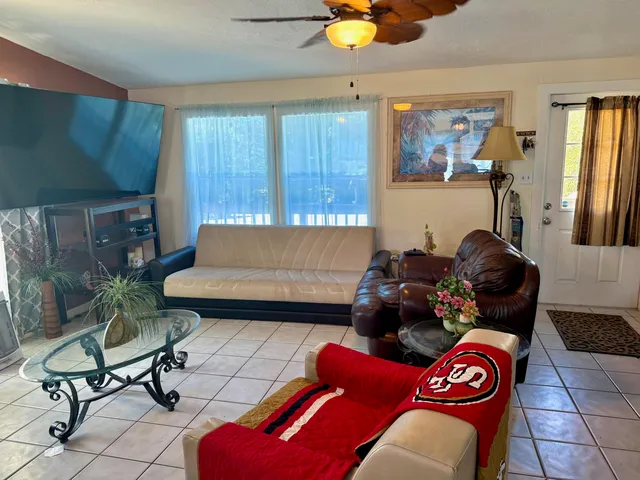 a living room with furniture and a lamp