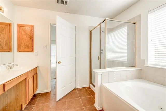 a bathroom with a tub sink and a window