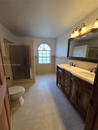 a bathroom with a sink a toilet and mirror