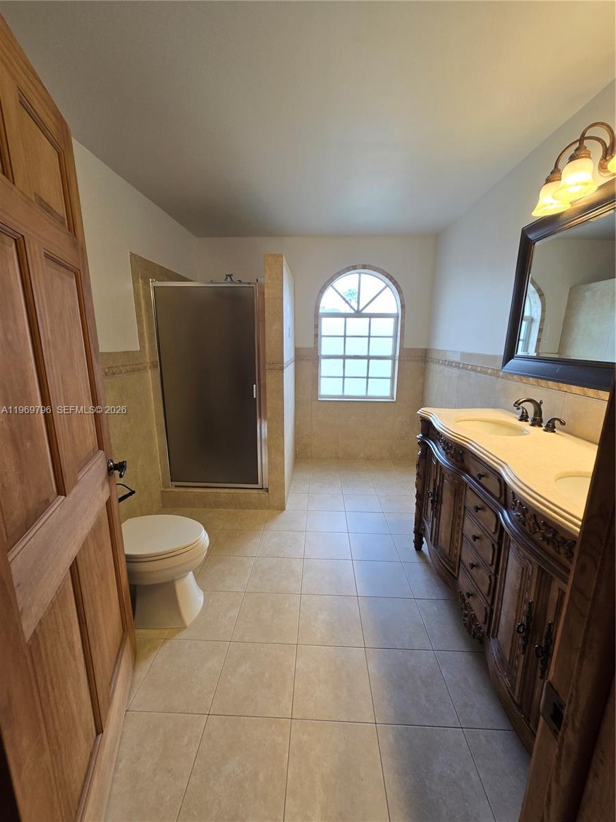14611 Balgowan Road, Unit 2041 Miami Lakes, FL 33016 - Photo 12 of 22 a bathroom with a sink a toilet and mirror