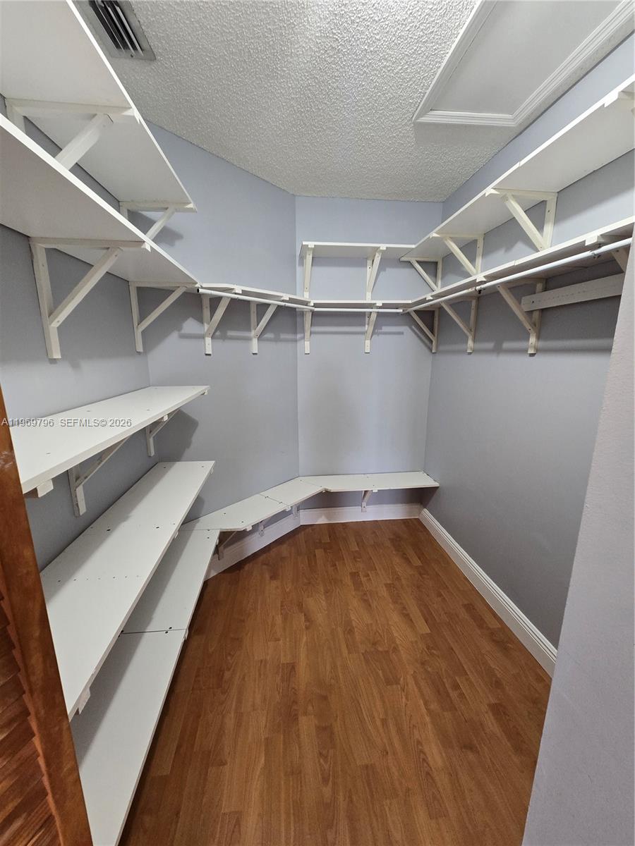 14611 Balgowan Road, Unit 2041 Miami Lakes, FL 33016 - Photo 13 of 22 a view of a room with racks on the wall