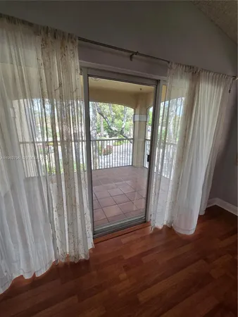 a view of entryway with wooden floor and door