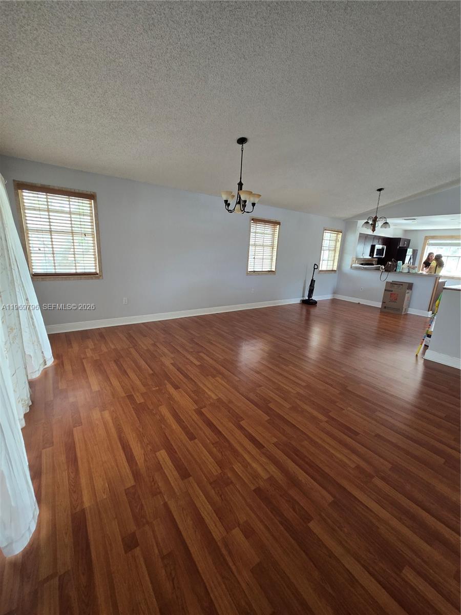 14611 Balgowan Road, Unit 2041 Miami Lakes, FL 33016 - Photo 3 of 22 wooden floor in an empty room with a window