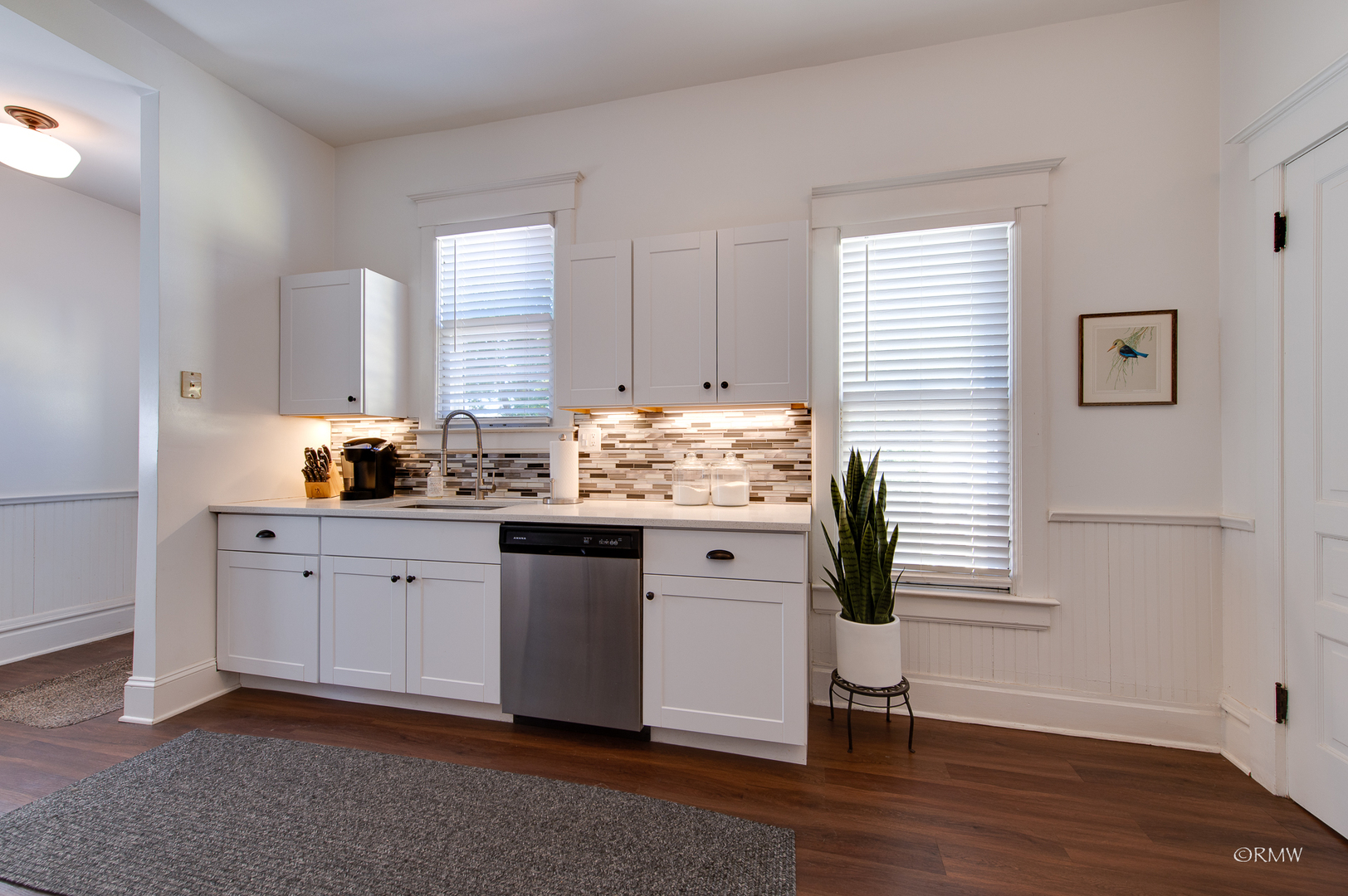 414 North Spring Street Elgin, IL 60120 - Photo 18 of 51 a kitchen with granite countertop white cabinets and white appliances