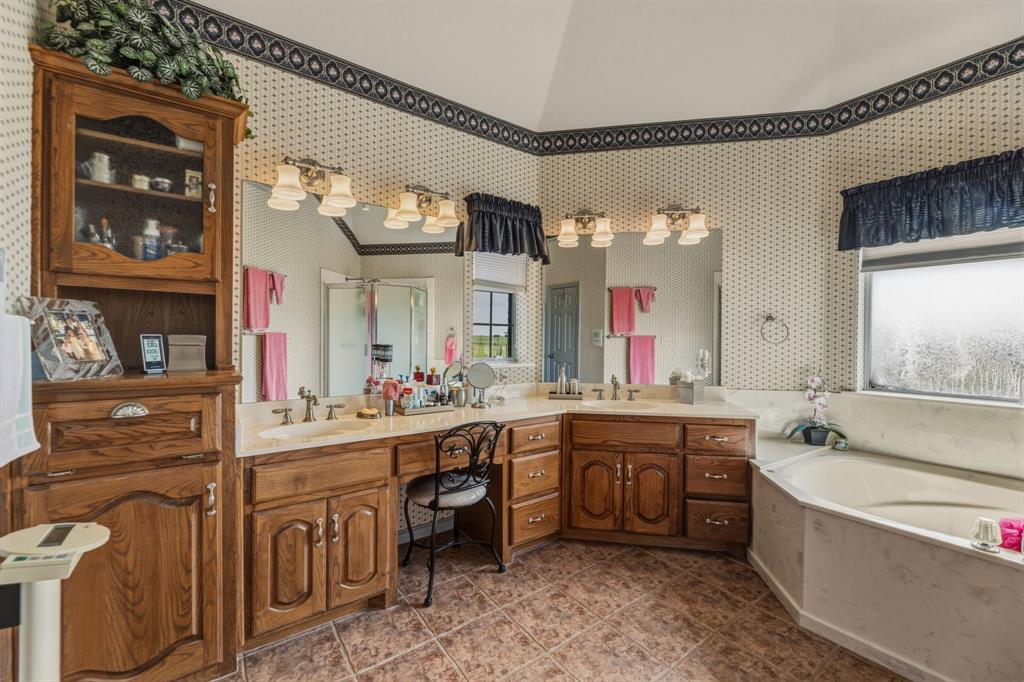 130 Blazek Road Alma, TX 75119 - Photo 17 of 34 a large bathroom with a large tub sink and mirror