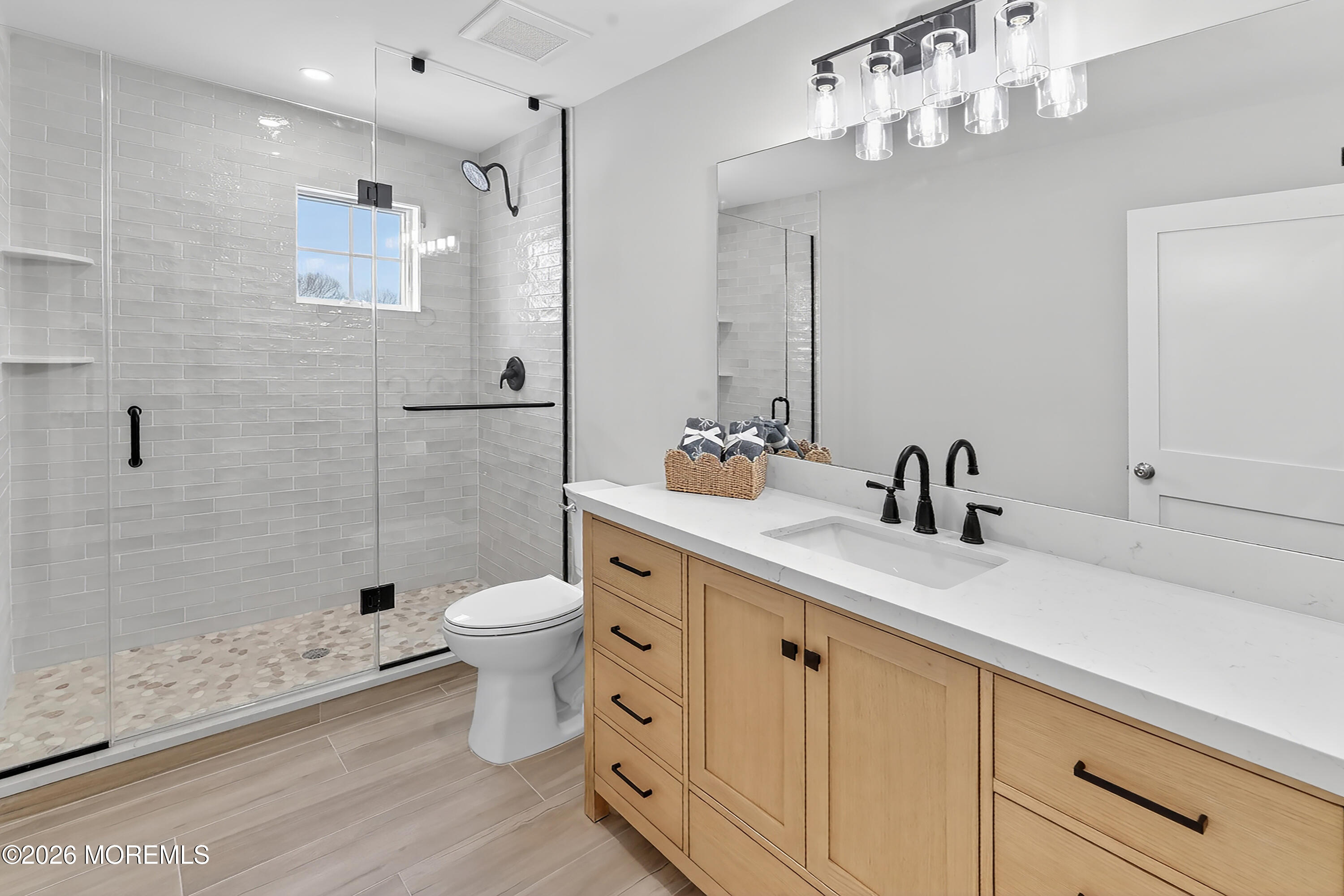 909 Jersey Avenue Spring Lake Heights, NJ 07762 - Photo 35 of 57 a bathroom with a double vanity sink mirror and toilet