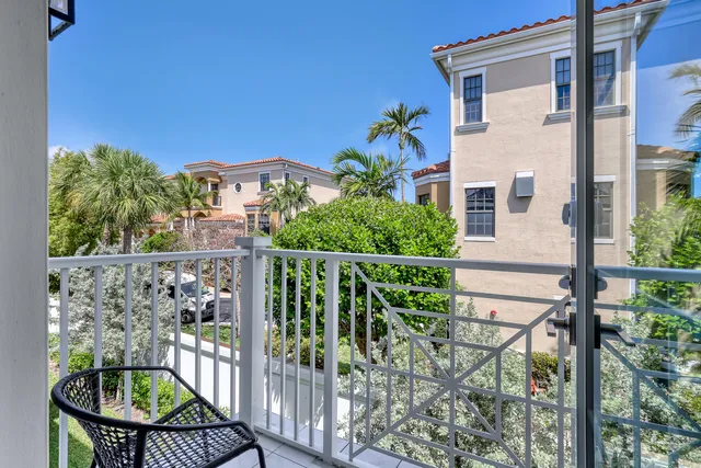 a view of a balcony with chairs