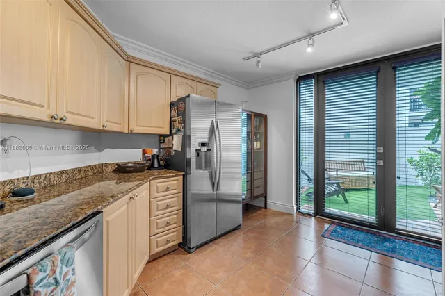 a kitchen with stainless steel appliances granite countertop a refrigerator and a sink