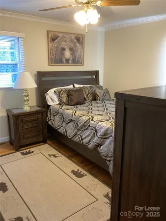 a bed sitting in a bedroom next to a window