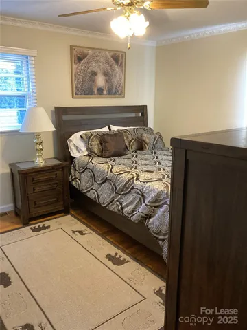 a bed sitting in a bedroom next to a window