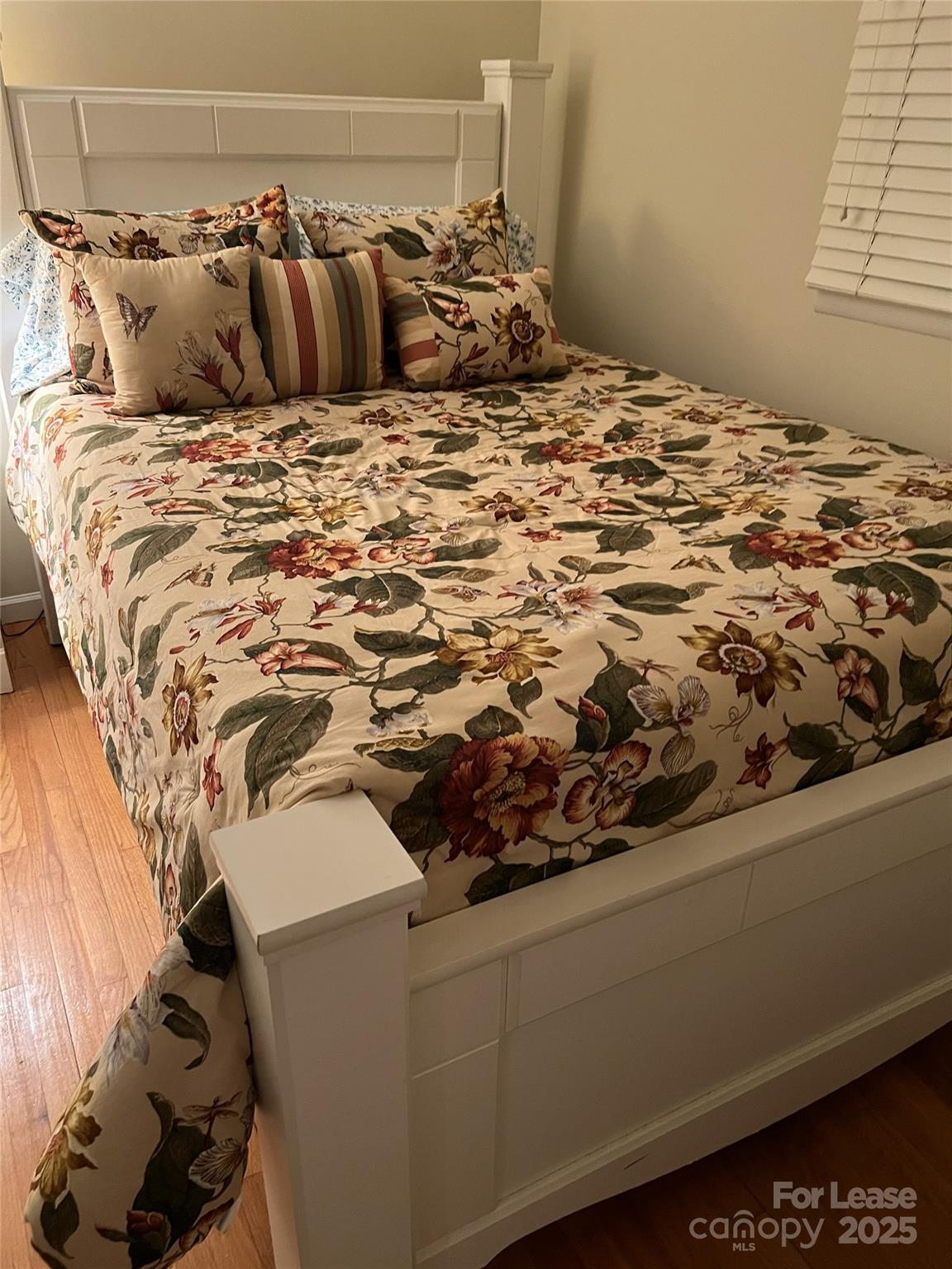 179 Rutledge Road Fletcher, NC 28732 - Photo 16 of 28 a bed sitting in a bedroom next to a window