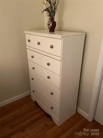 a bed sitting in a bedroom next to a lamp