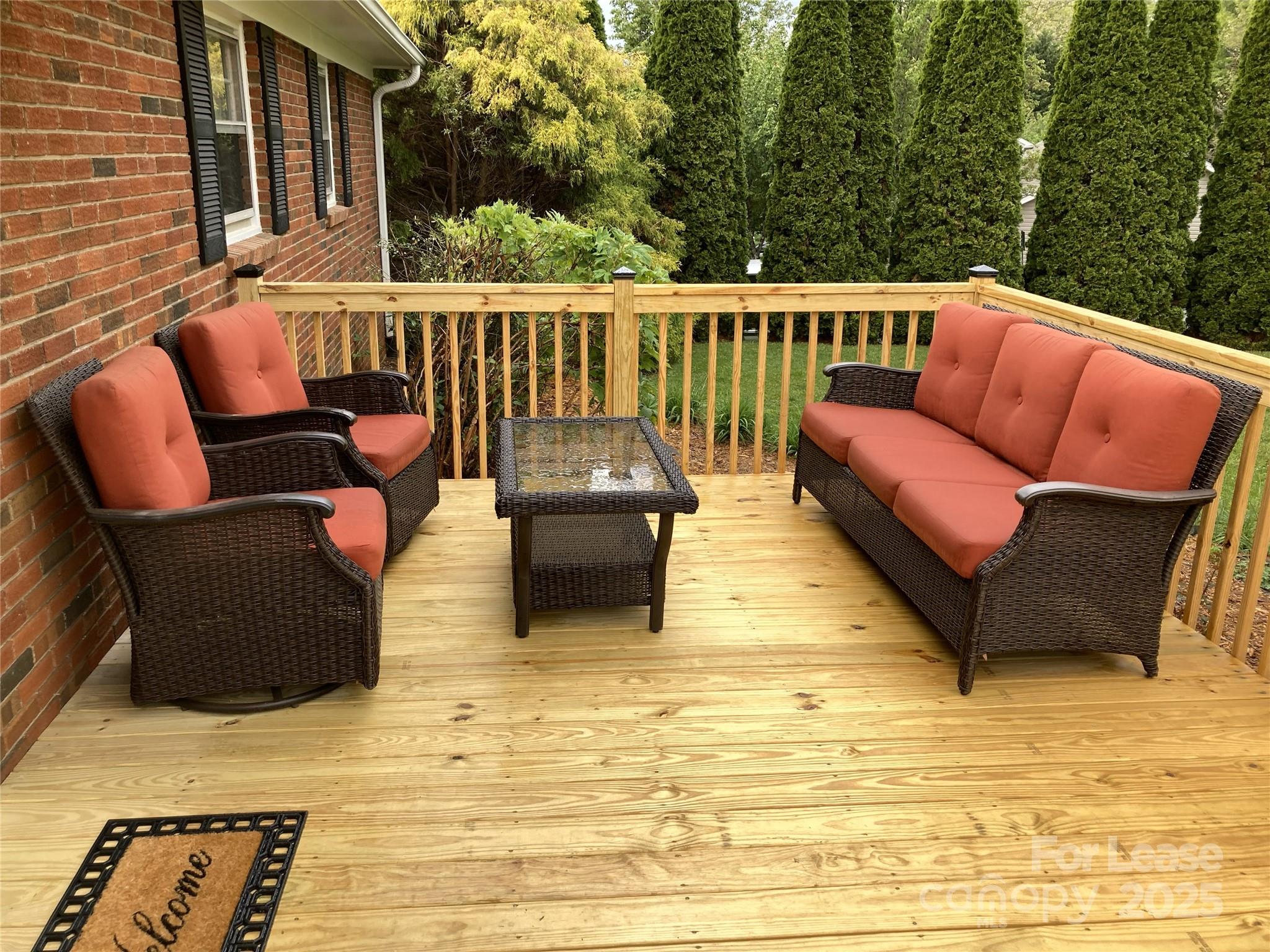 179 Rutledge Road Fletcher, NC 28732 - Photo 2 of 28 a balcony with wooden floor and furniture