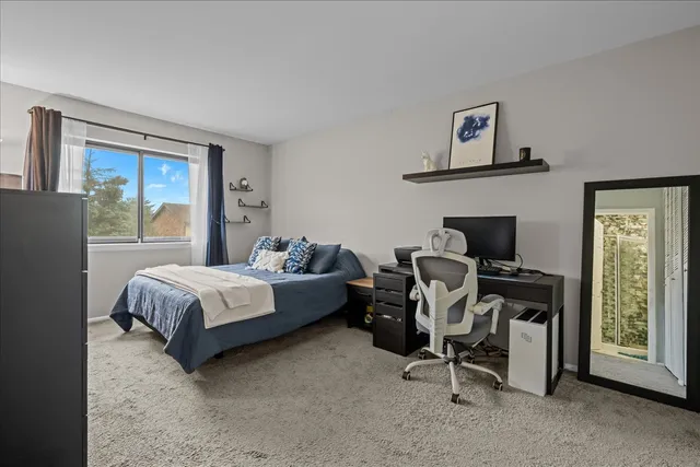 a bedroom with a bed and a chair