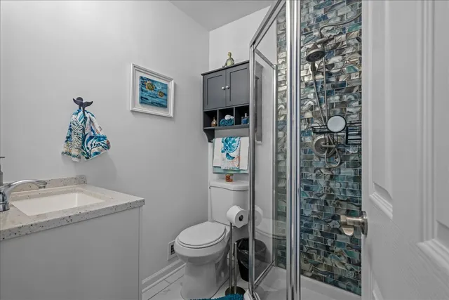 a white toilet sitting next to a bathroom sink